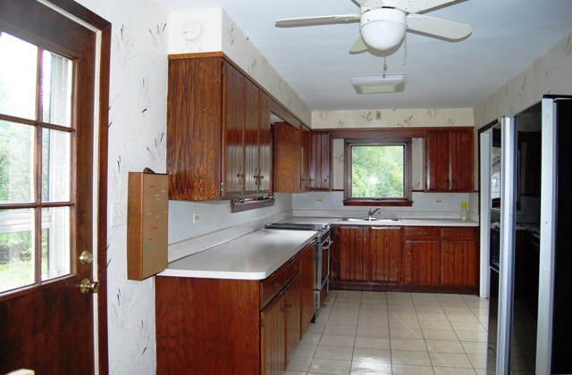 2160 Dehne Road Northbrook, IL 60062 - Photo 5 of 15 a kitchen with kitchen island granite countertop a sink stainless steel appliances cabinets and a large window