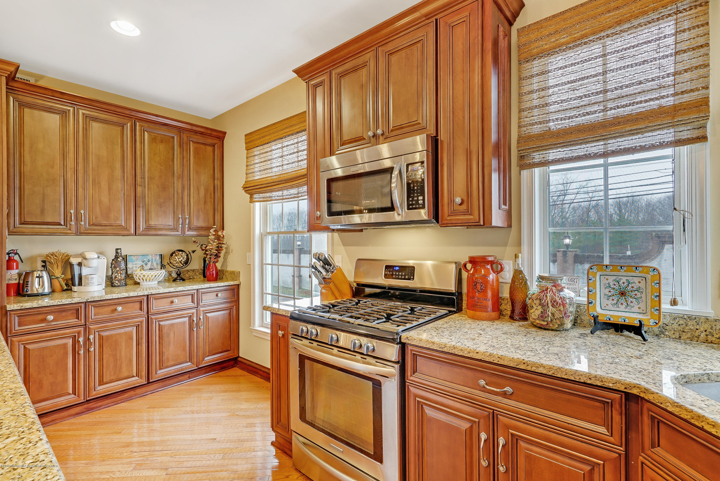 18 Mariners Bend Brielle, NJ 08730 - Photo 11 of 31 a kitchen with stainless steel appliances granite countertop a stove a sink and a microwave