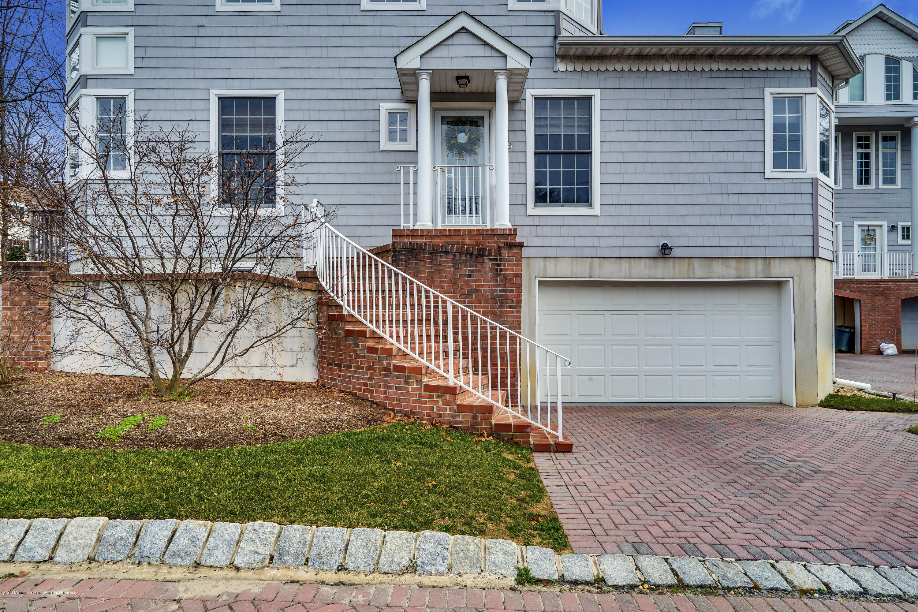 18 Mariners Bend Brielle, NJ 08730 - Photo 28 of 31 a front view of a house with a yard and garage