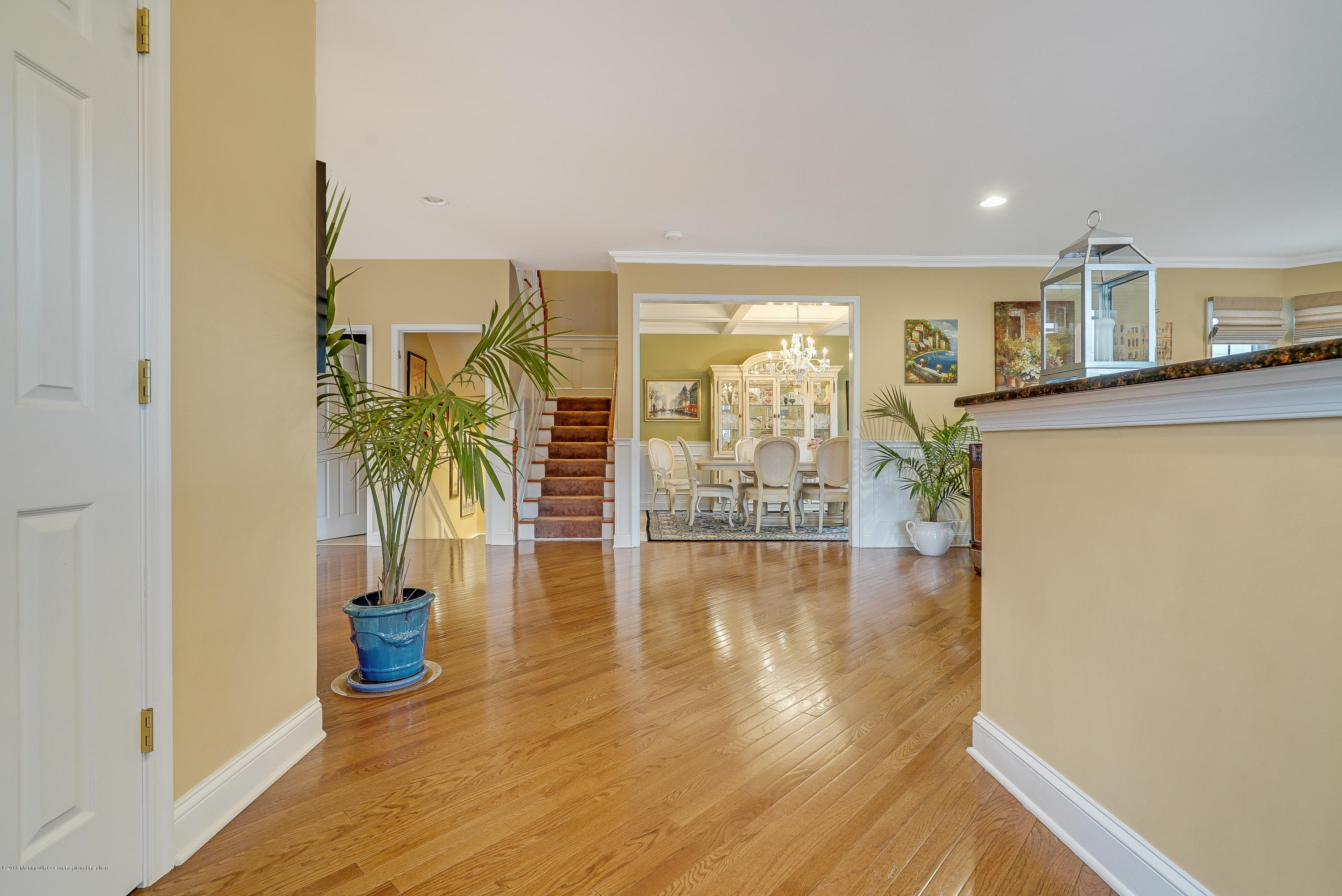 18 Mariners Bend Brielle, NJ 08730 - Photo 4 of 31 a view of a hallway with wooden floor and a potted plant