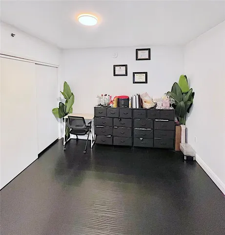 a bed room with furniture and a potted plant