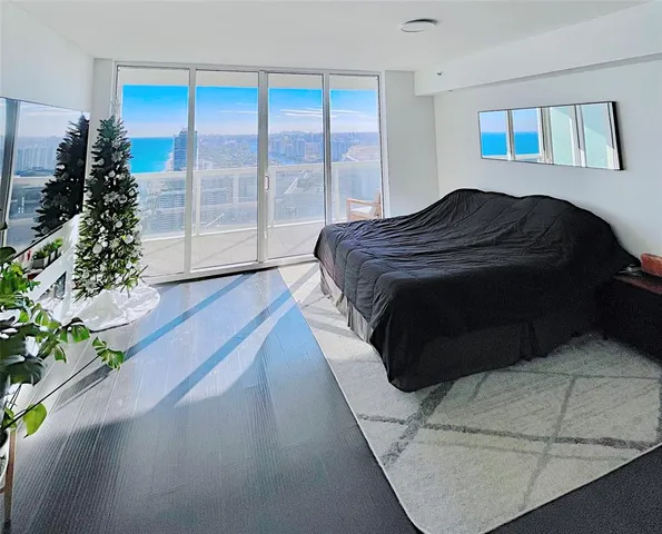 a bedroom with a bed and a large window