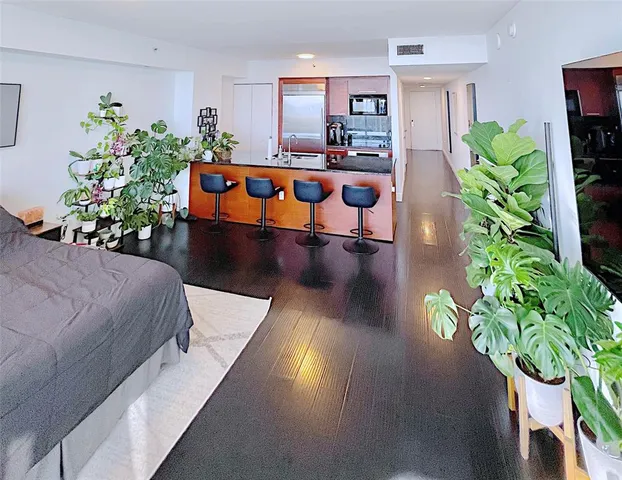 a living room with furniture potted plant and a table