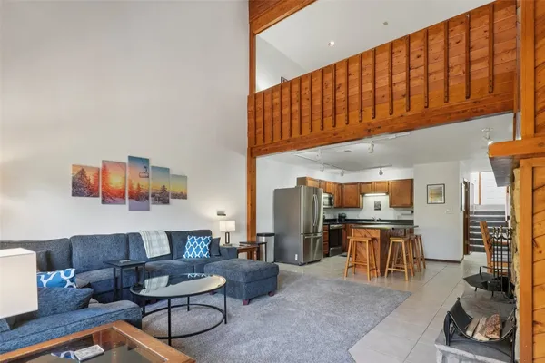 a living room with furniture a fireplace and a piano