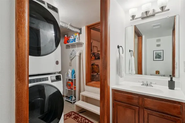 a utility room with mirror dryer and washer
