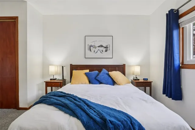 a bed room with a bed and a night stand