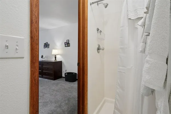 a bedroom with two beds and a lamp