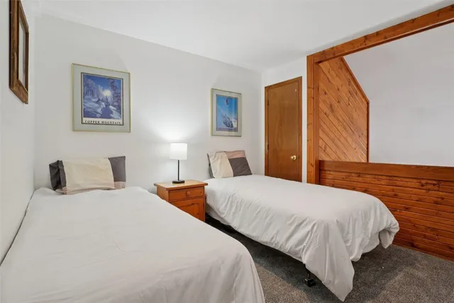 a bedroom with two beds and painted walls