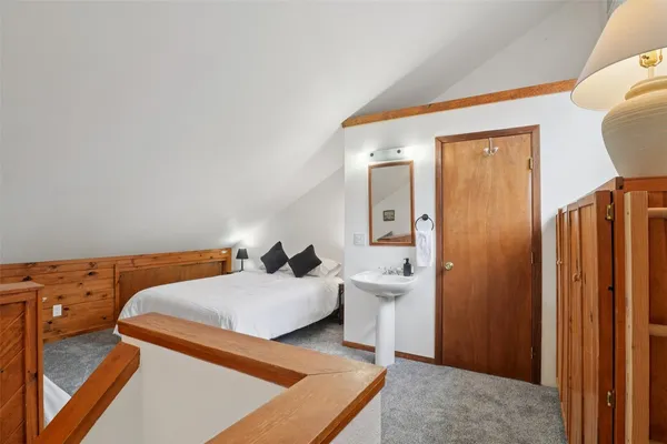 a bedroom with two beds and a dresser