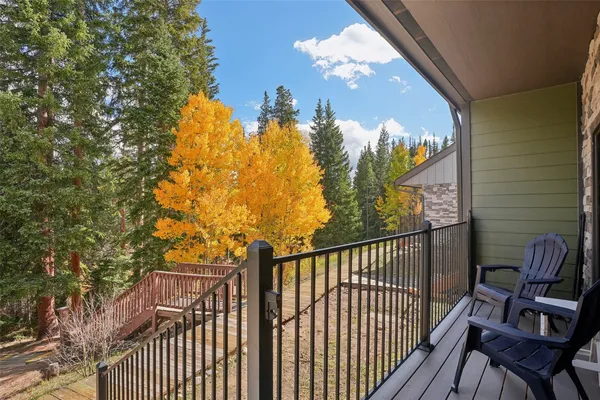 a view of a house with a patio and a yard