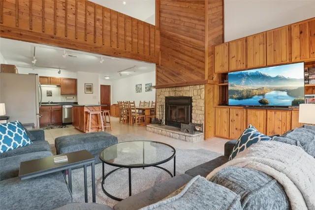 a living room with furniture a fireplace and kitchen view