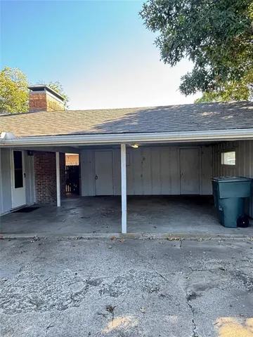 a view of a house with a large tree