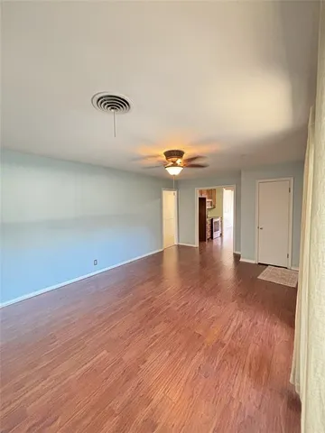 a view of a room with wooden floor