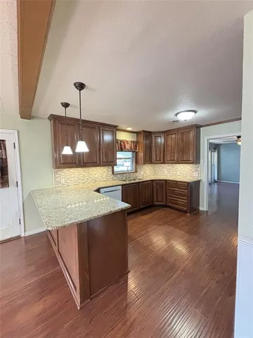 a kitchen with stainless steel appliances granite countertop a sink and a stove