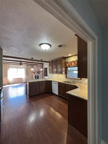 a view of large kitchen with cabinets