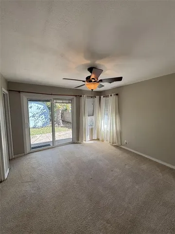 a view of large room with windows and chandelier