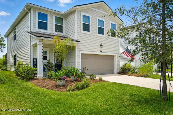 a front view of a house with a yard and garage