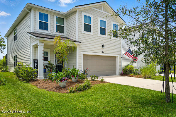 105 Meadow Creek Drive St. Johns, FL 32259 - Photo 1 of 37 a front view of a house with a yard and garage