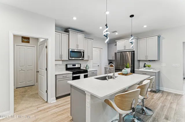 a kitchen that has a lot of counter space and wooden floor