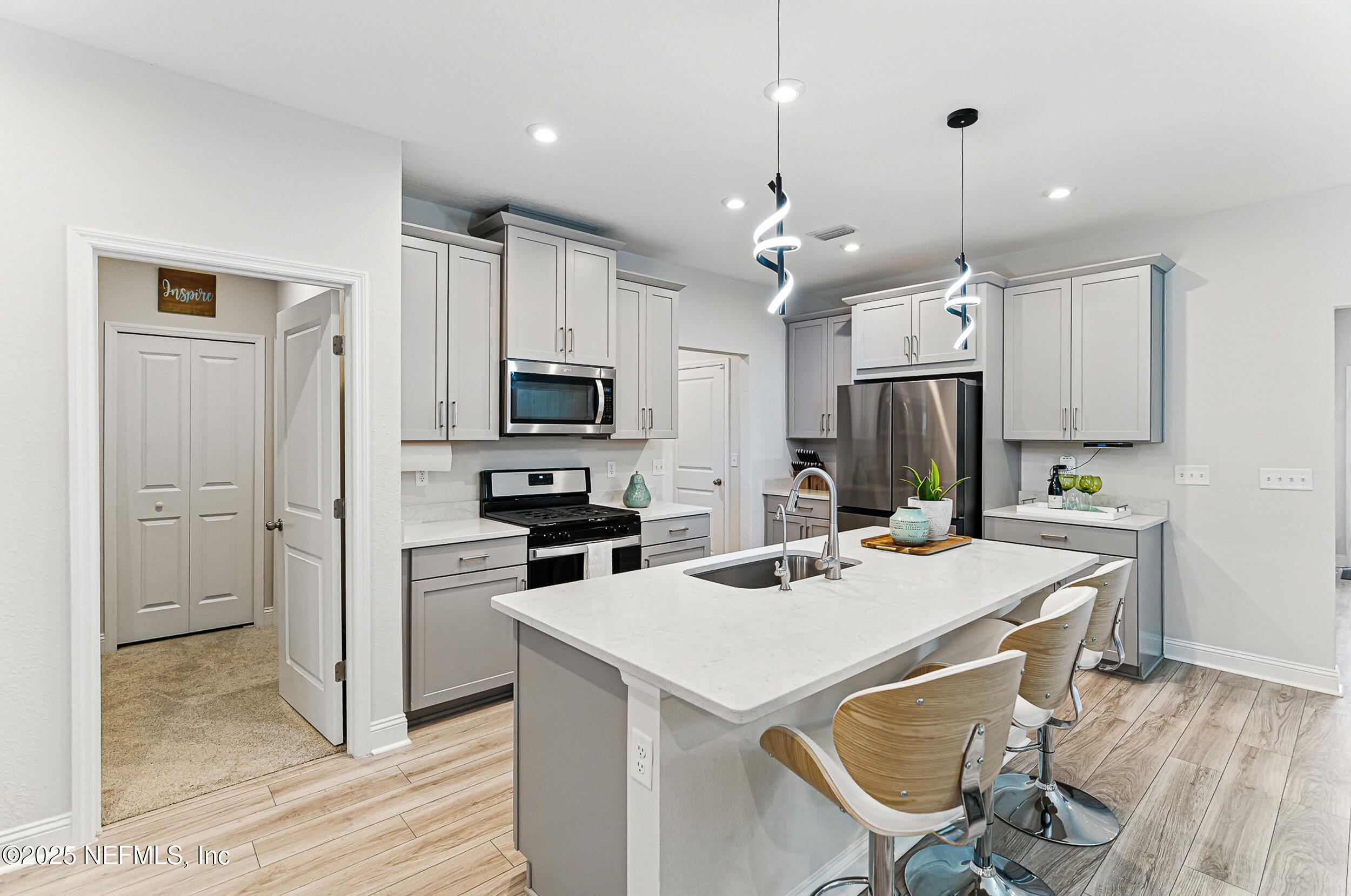 105 Meadow Creek Drive St. Johns, FL 32259 - Photo 13 of 37 a kitchen that has a lot of counter space and wooden floor