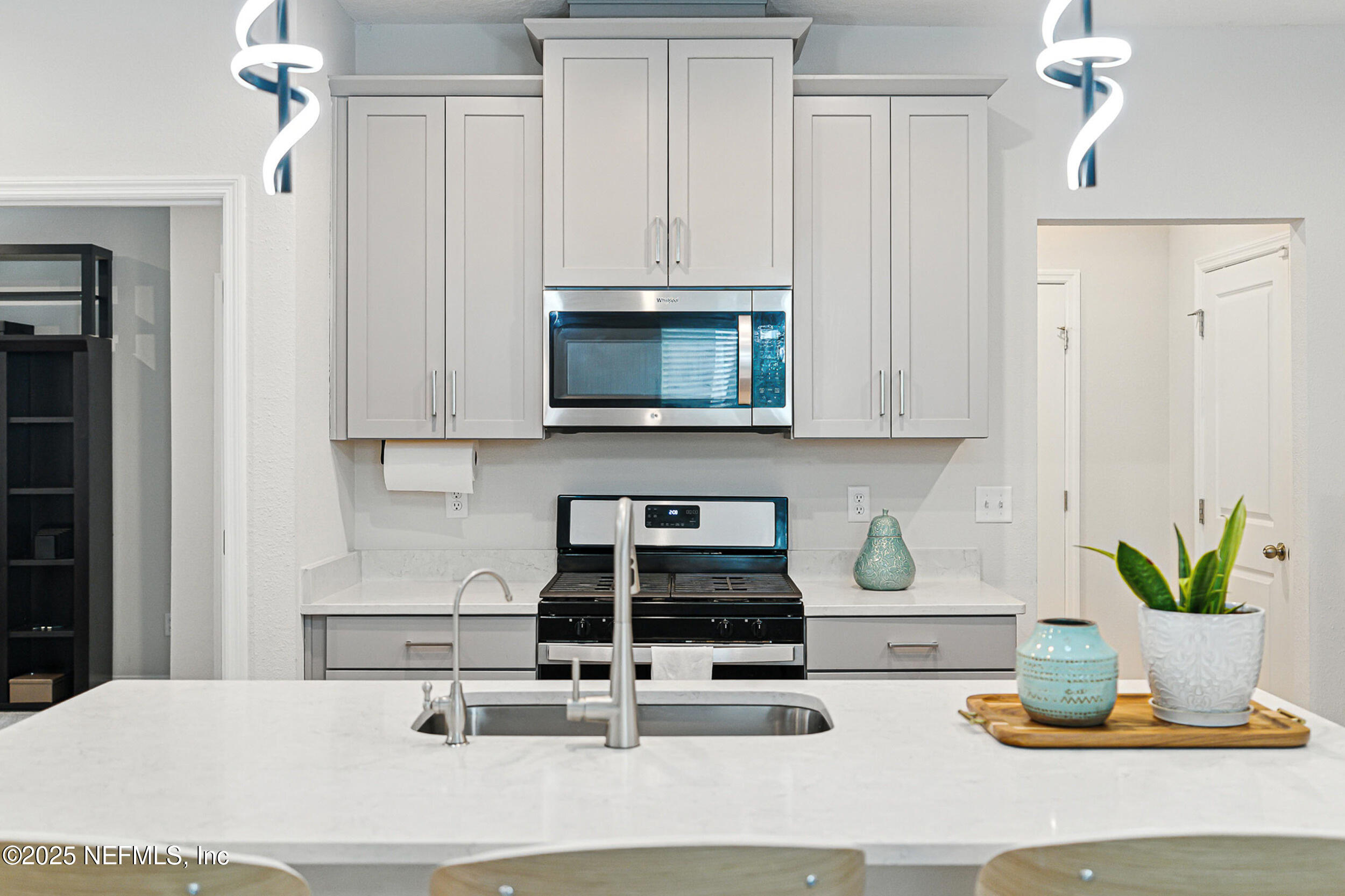 105 Meadow Creek Drive St. Johns, FL 32259 - Photo 15 of 37 a kitchen with a appliances a cabinets and a potted plant