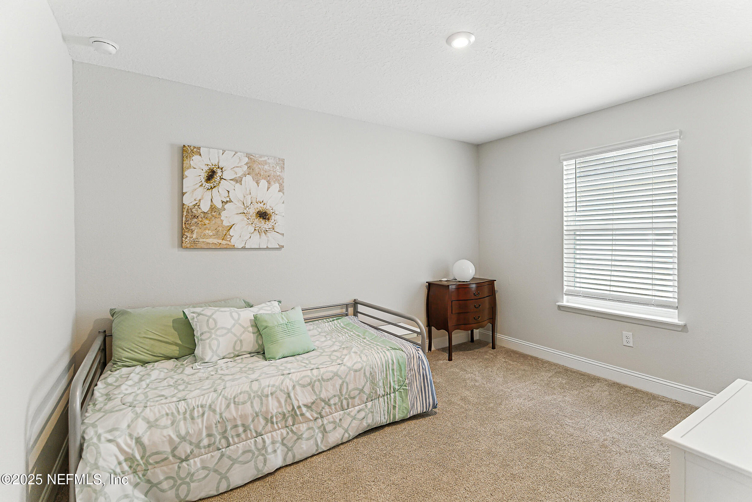 105 Meadow Creek Drive St. Johns, FL 32259 - Photo 21 of 37 a spacious bedroom with a bed and a chair