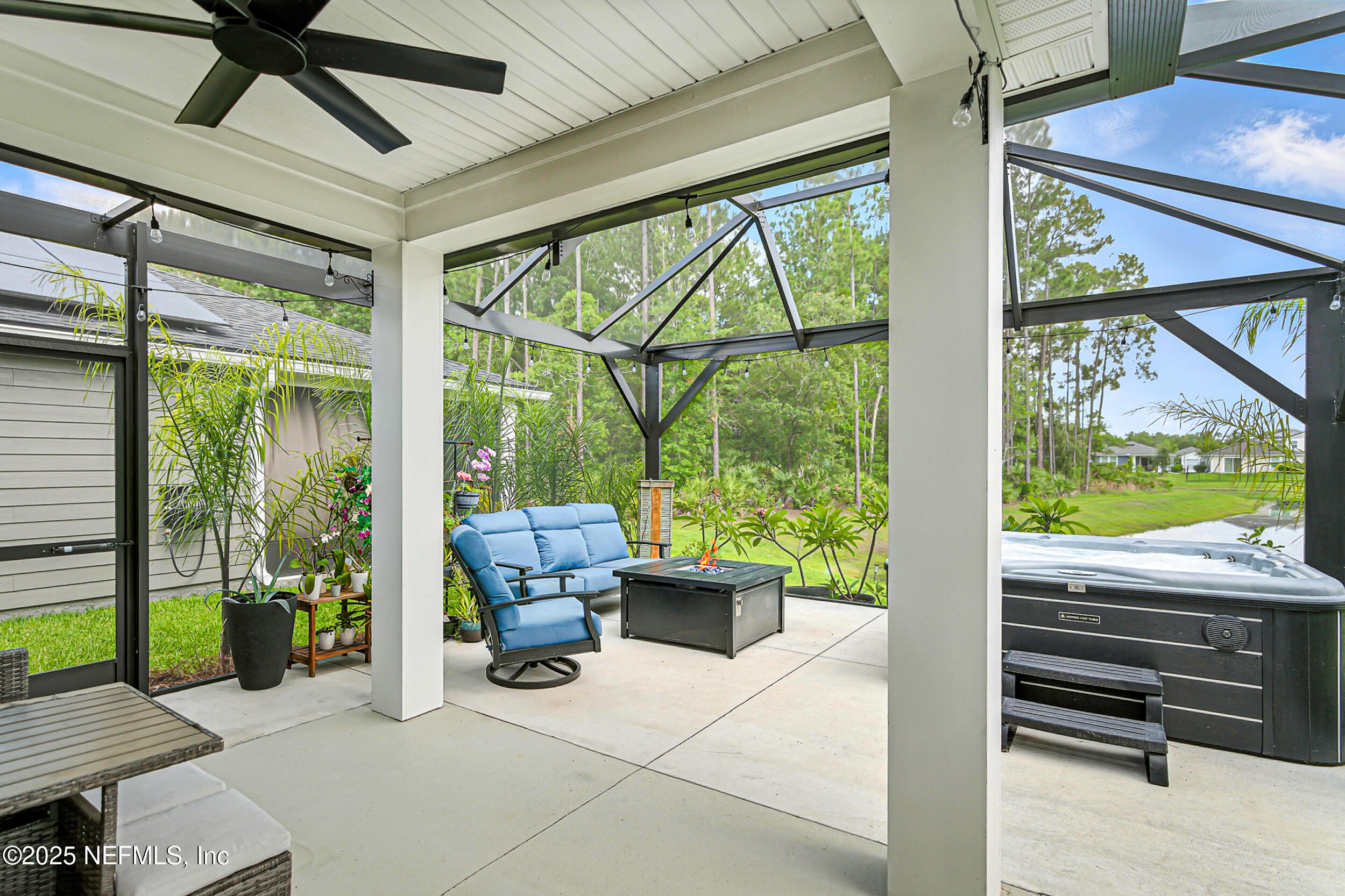 105 Meadow Creek Drive St. Johns, FL 32259 - Photo 28 of 37 a living room with patio furniture and a floor to ceiling window