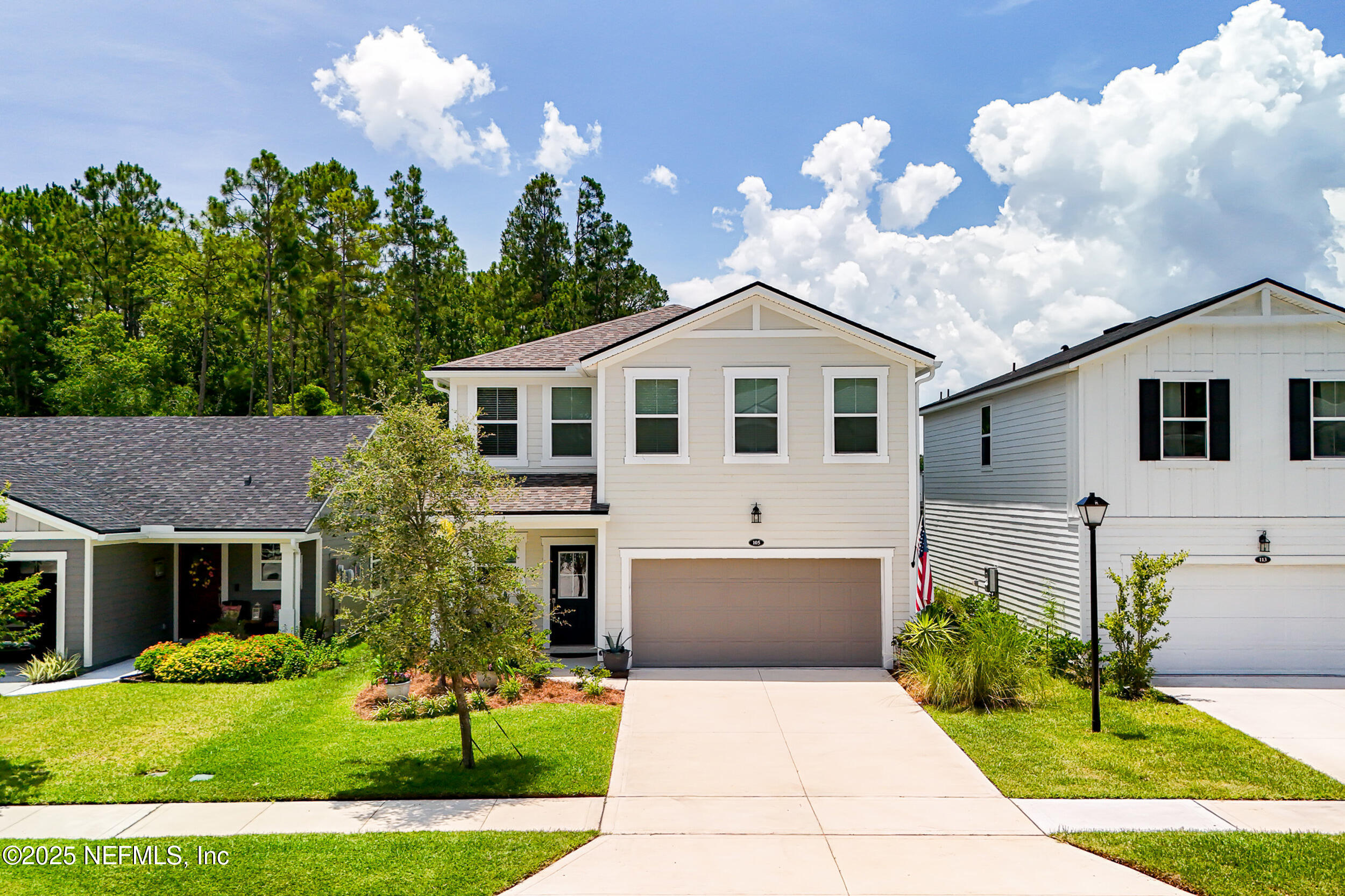 105 Meadow Creek Drive St. Johns, FL 32259 - Photo 34 of 37 a front view of a house with a yard and potted plants