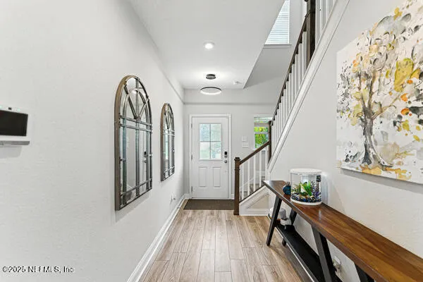 a view of entryway with wooden floor and stairs