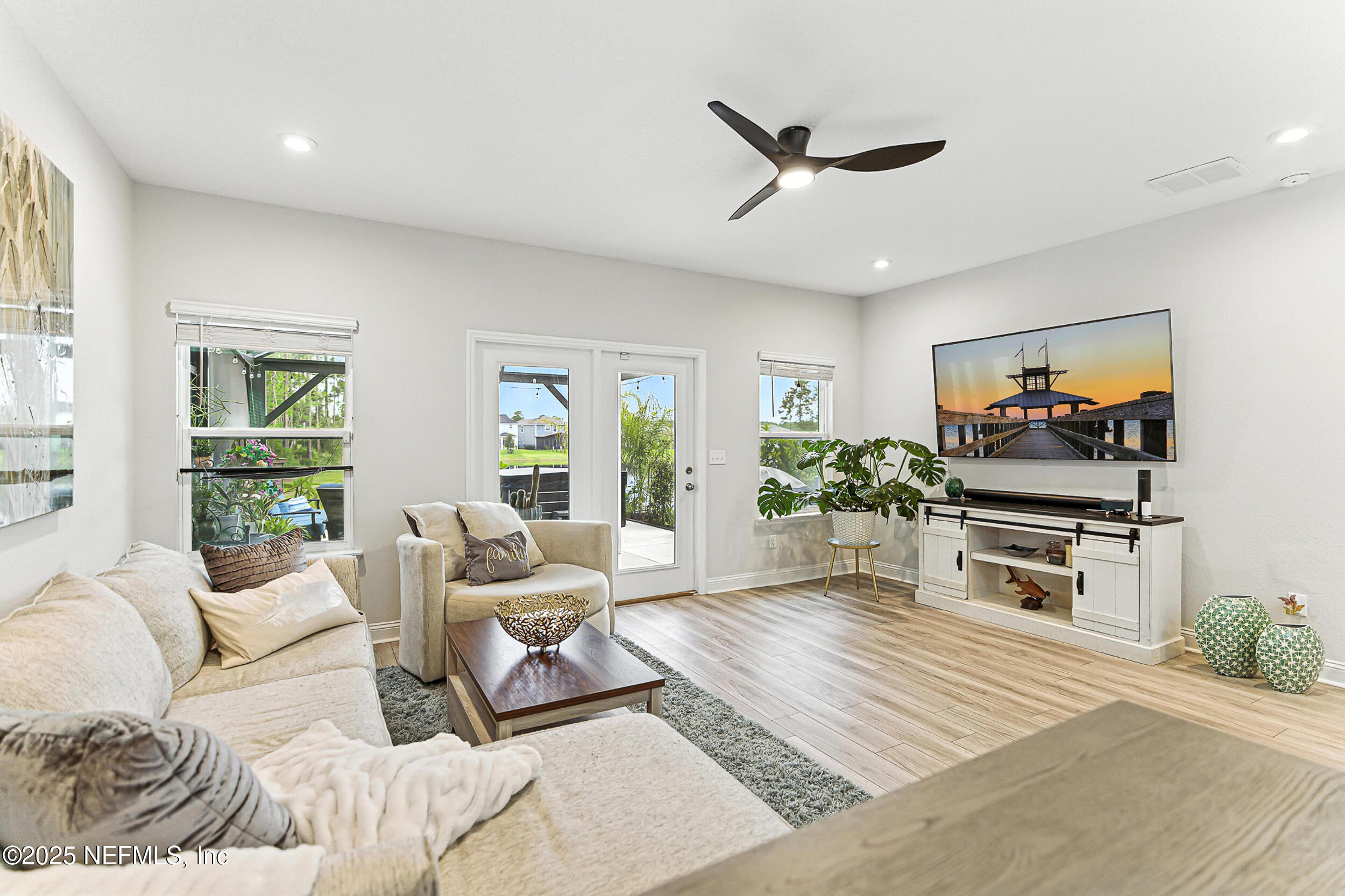 105 Meadow Creek Drive St. Johns, FL 32259 - Photo 5 of 37 a living room with furniture a window and a flat screen tv