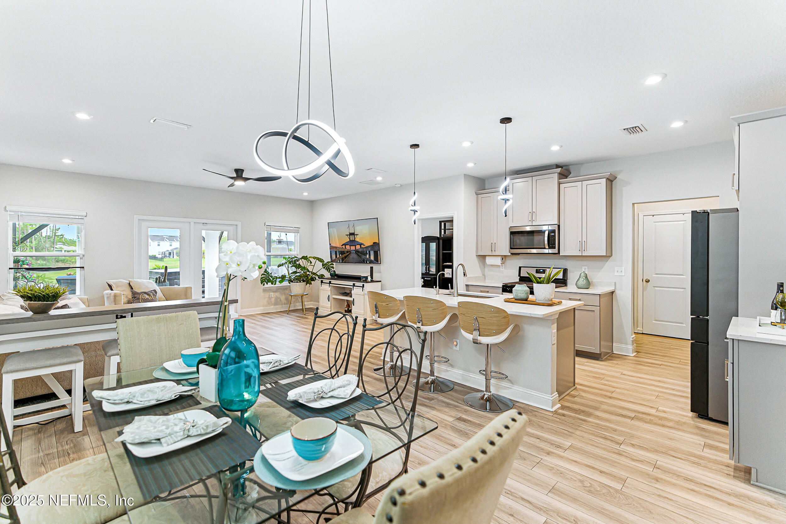 105 Meadow Creek Drive St. Johns, FL 32259 - Photo 10 of 37 a view of a dining room and livingroom with furniture wooden floor kitchen view
