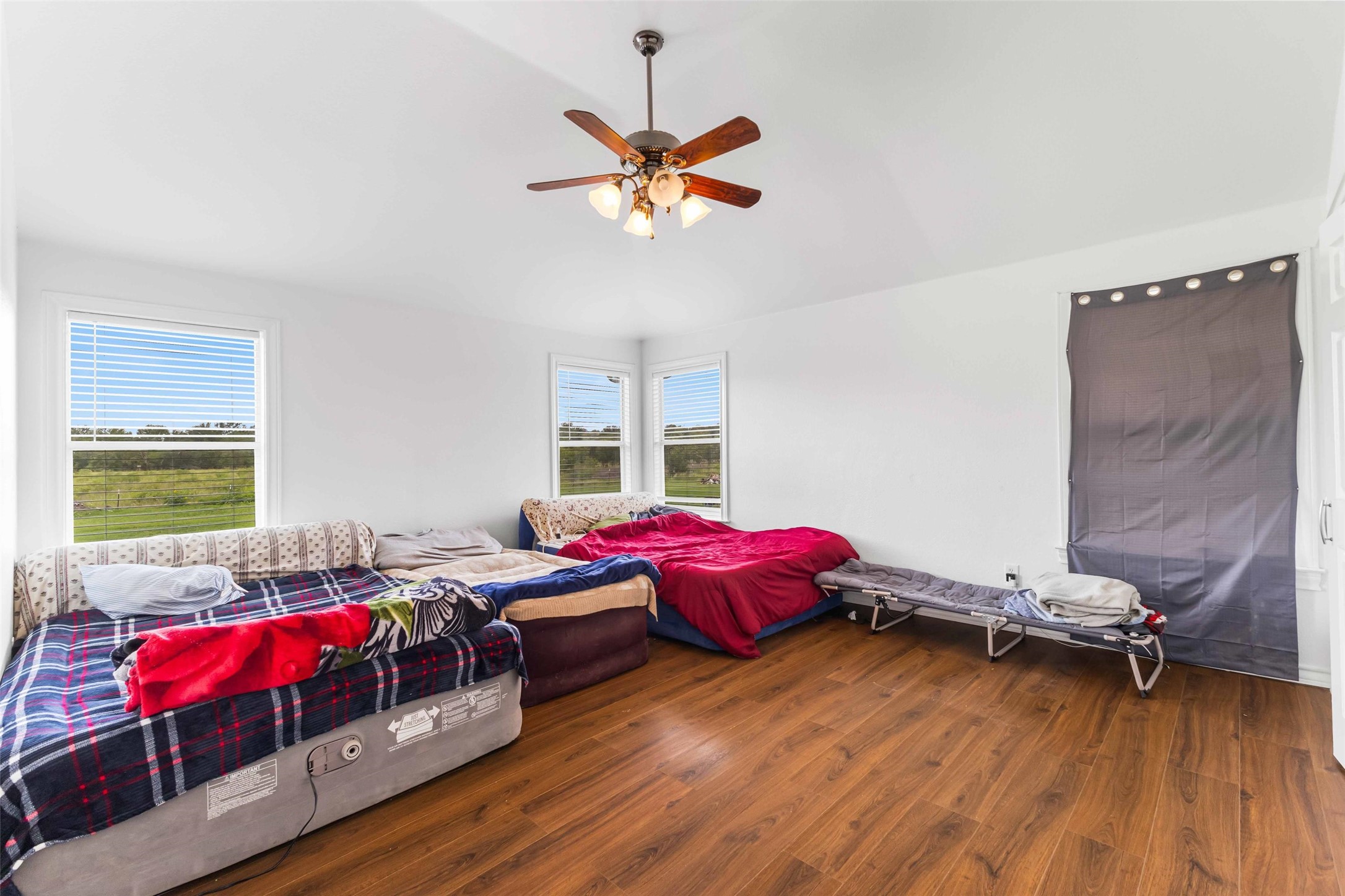 12212 Ballerstedt Road Elgin, TX 78621 - Photo 16 of 39 Bedroom with dark wood-style flooring, vaulted ceiling, and ceiling fan