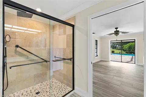 a bathroom with a glass shower door