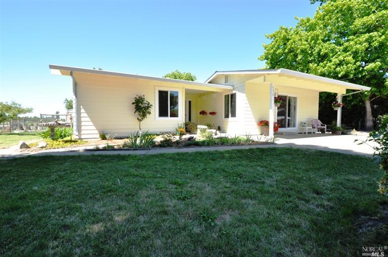 a front view of house with yard and seating area