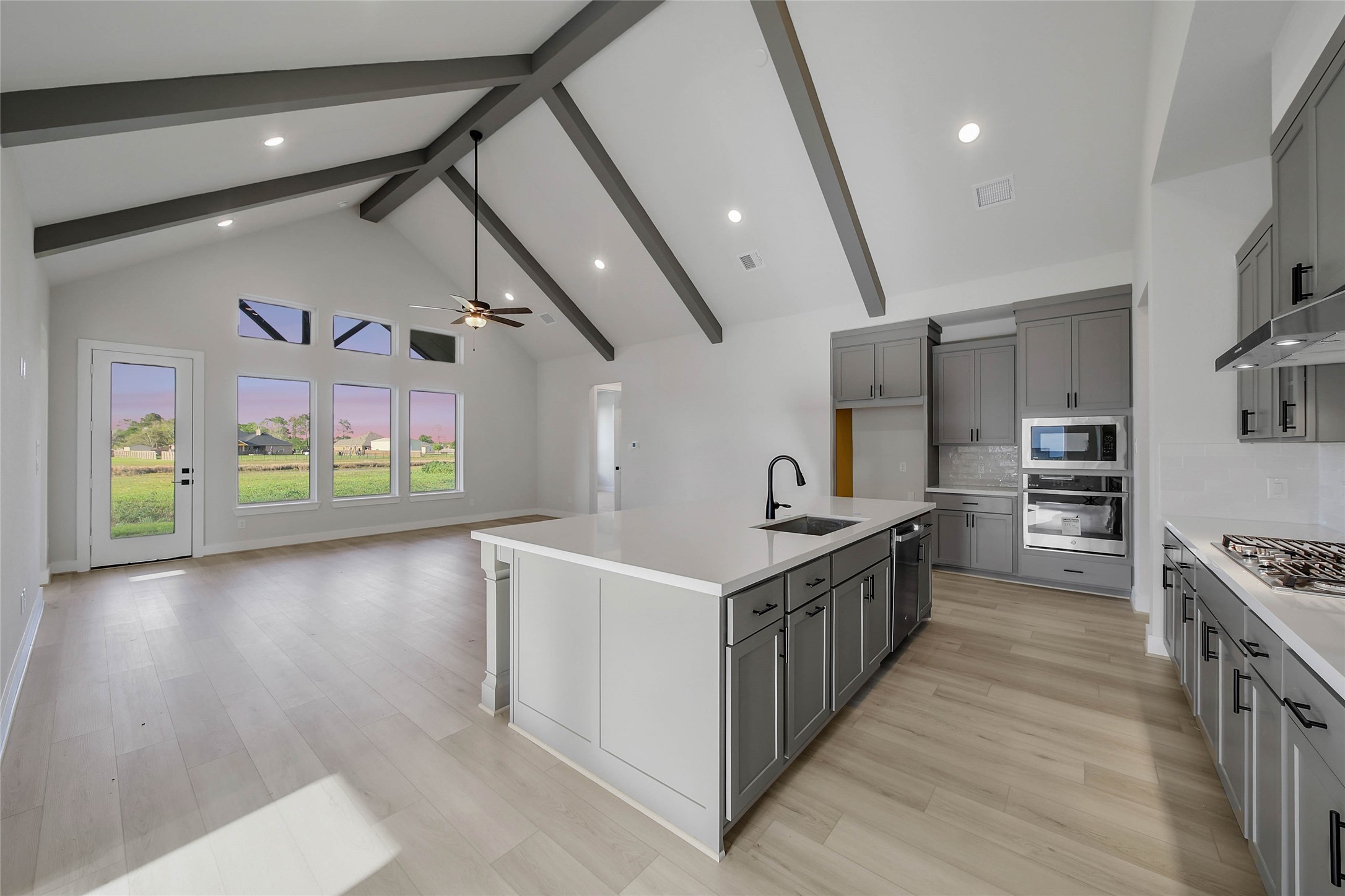 4519 Magnolia Bend Drive Rosharon, TX 77583 - Photo 7 of 48 a kitchen with stainless steel appliances a sink and a wooden floor
