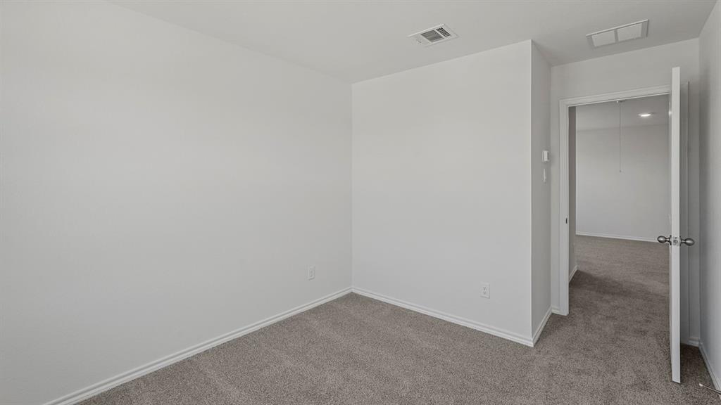 1627 Mantle Road Crandall, TX 75114 - Photo 39 of 40 Neutral wall color, carpeted flooring, and white trim
