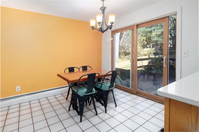a view of a dining room with furniture and chandelier