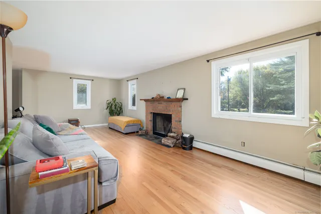a living room with furniture a window and a fireplace