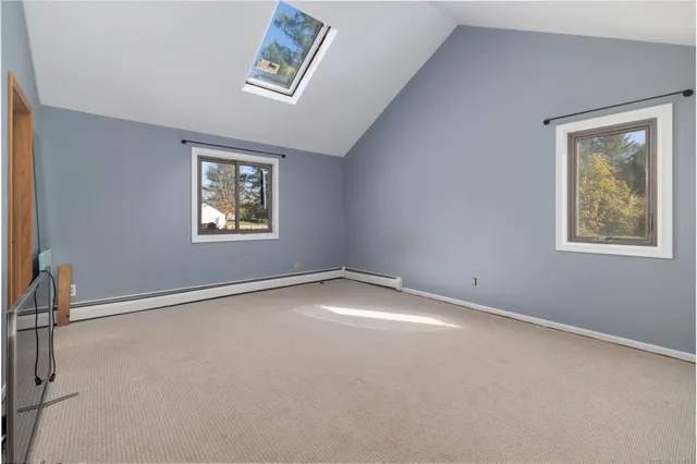 an empty room with windows and closet