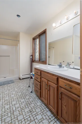 a bathroom with a granite countertop sink a toilet and a mirror