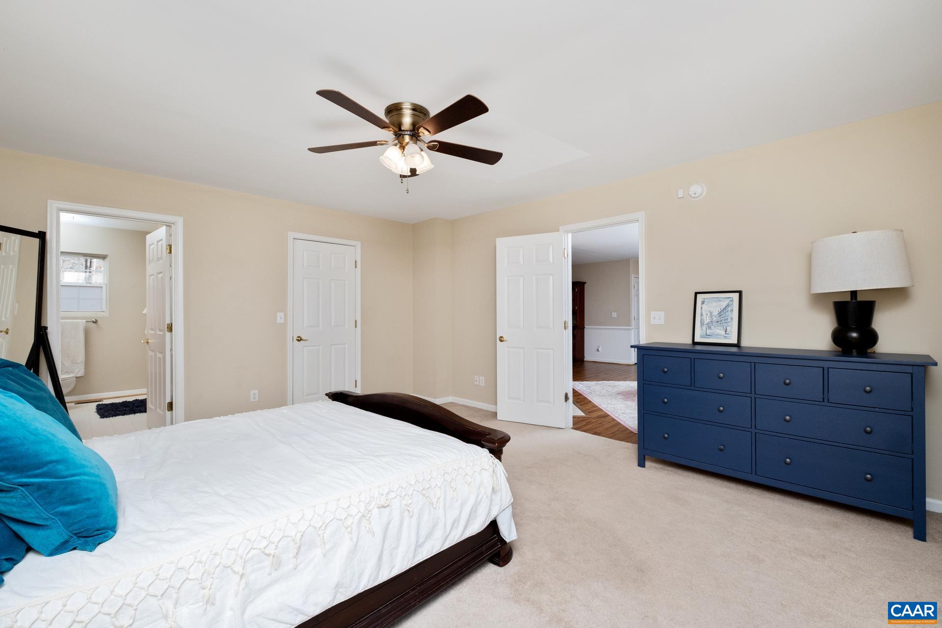 3 Powhatan Road Palmyra, VA 22963 - Photo 12 of 42 a bedroom with a bed and a chandelier