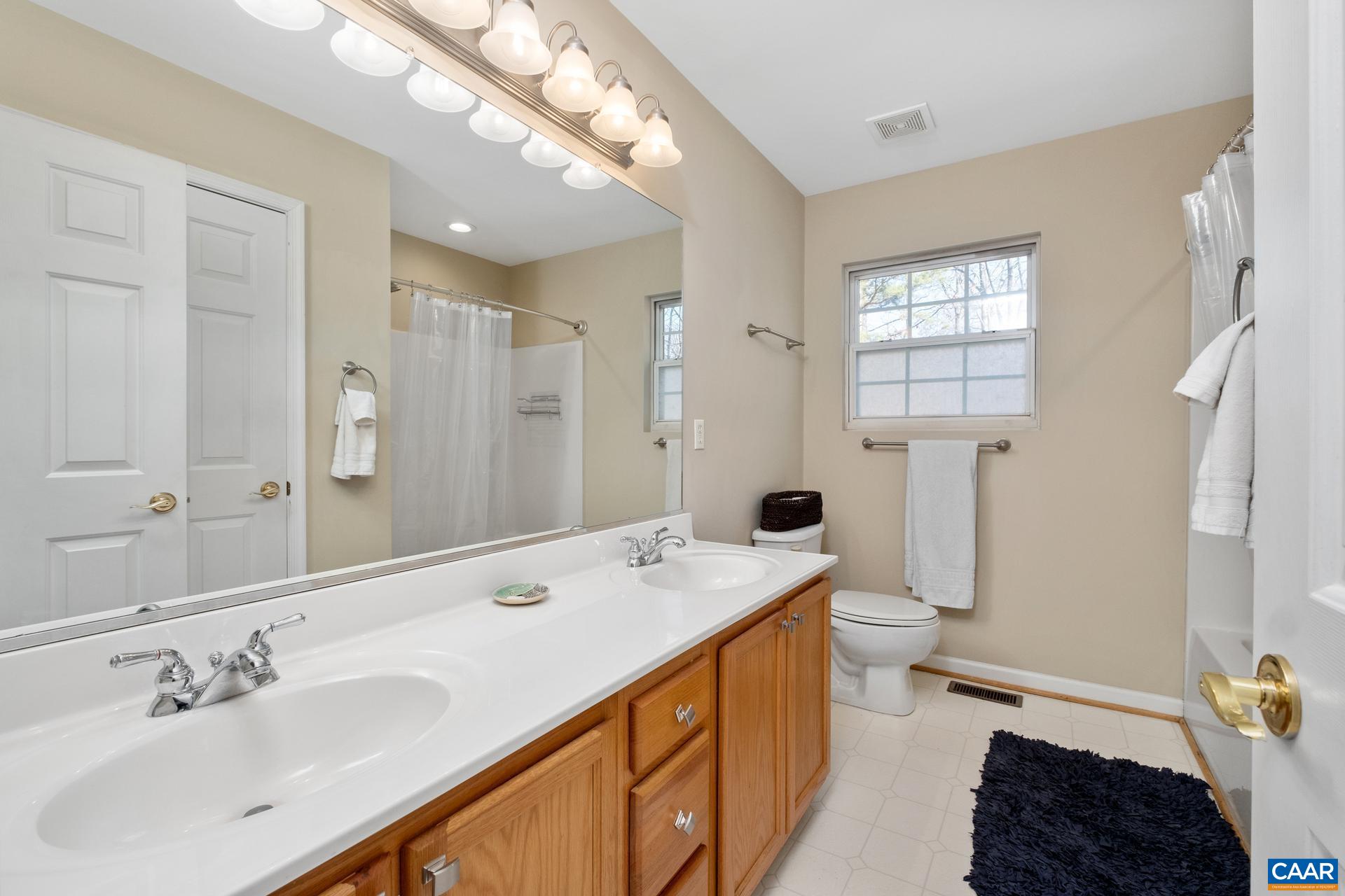 3 Powhatan Road Palmyra, VA 22963 - Photo 13 of 42 a spacious bathroom with a double vanity sink a mirror and a bathtub