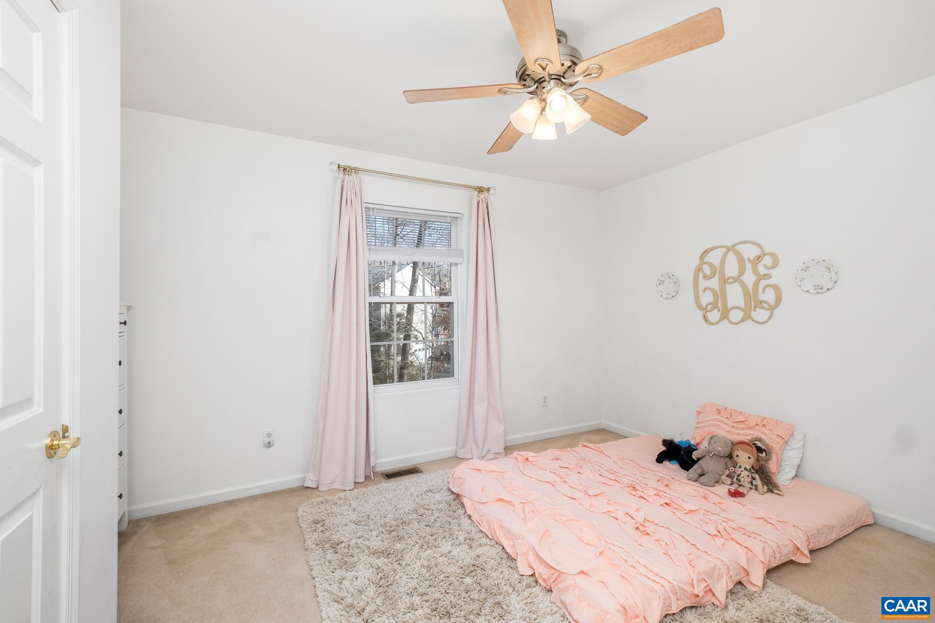 3 Powhatan Road Palmyra, VA 22963 - Photo 18 of 42 a bedroom with a bed and a chandelier