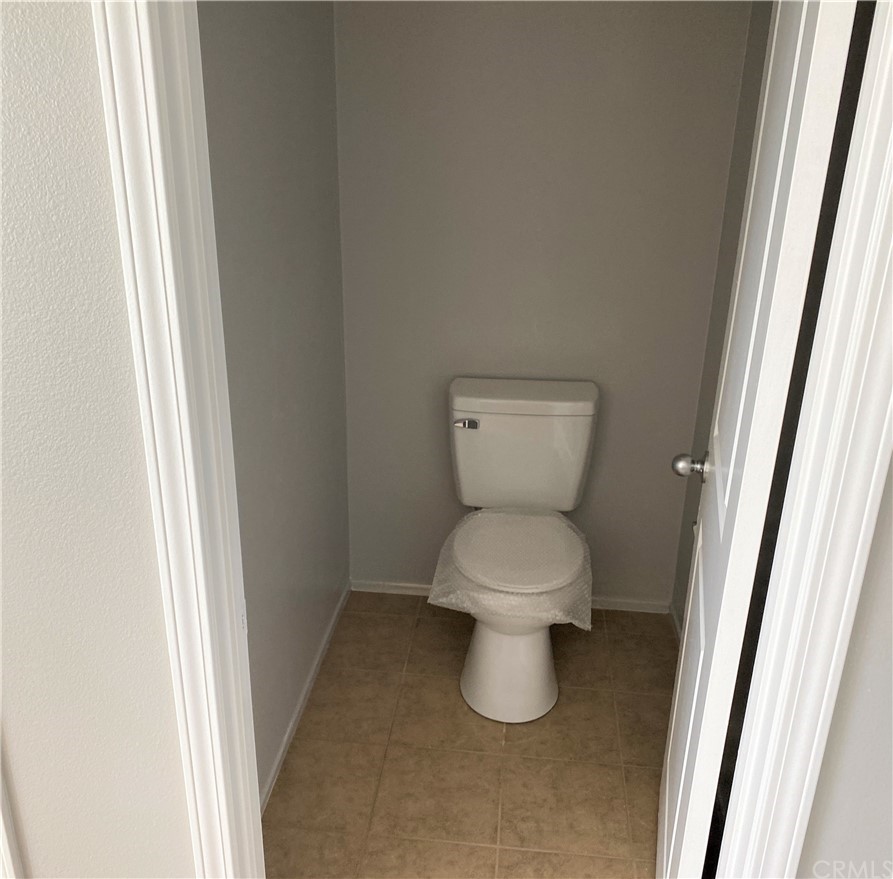 35123 Hulihee Street Winchester, CA 92596 - Photo 25 of 36 a white toilet sitting next to a small sink