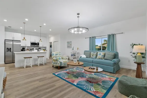 a living room with furniture and a chandelier
