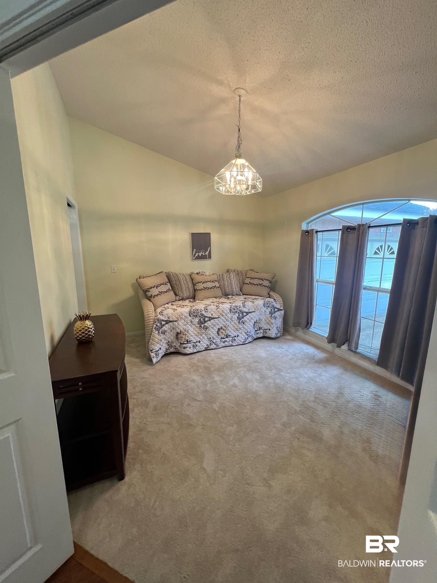2204 Club House Drive Lillian, AL 36549 - Photo 13 of 38 Carpeted bedroom with a chandelier and a textured ceiling
