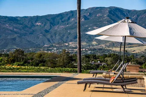 a view of a outdoor sitting area with furniture and backyard