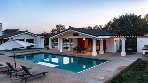 a front view of house with yard outdoor seating and barbeque in living room