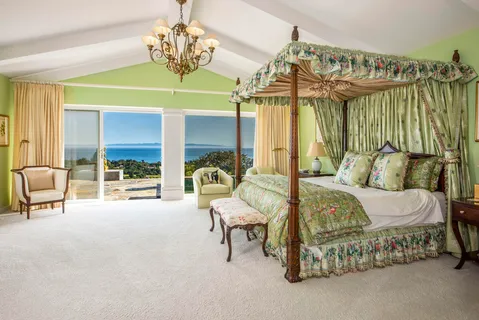 a bedroom with furniture and a chandelier