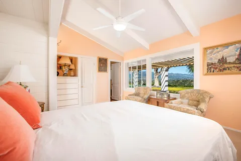 a bedroom with a large bed and a large window